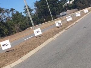  Andrew Archibald used these signs to pop the prom invitation to his girlfriend, sophomore Jaclyn Slater.