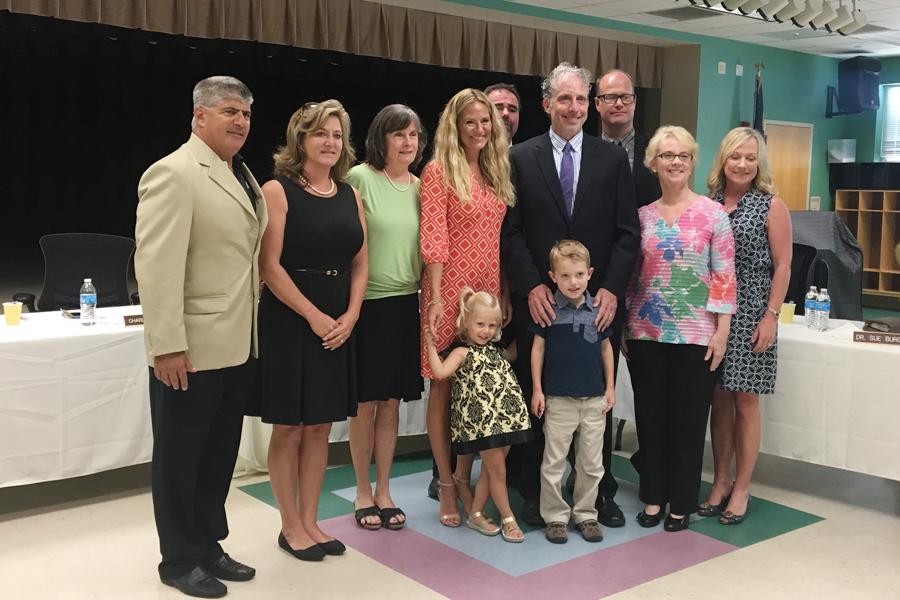 Members of the Dare County Schools Board of Education pose with new Superintendent John Farrelly and his family during Saturday's introduction. PHOTO BY BEVERLY MURRY/NIGHTHAWK NEWS