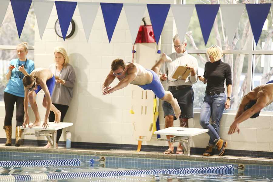 Senior Parker Sylvia dives in during a home meet last month at the Outer Banks Family YMCA. Sylvia and his teammates enjoyed an undefeated regular season and will look for continued success at conference, regionals and states. PHOTOS BY MICHAELA KELLY/Nighthawk News Magazine