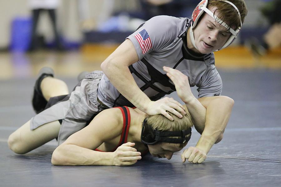 Senior Jeremiah Derby manhandles an opponent during last week's match against Currituck. Derby and several teammates will be top contenders for state championships again this year. PHOTO BY BEN TRAN/NIGHTHAWK NEWS