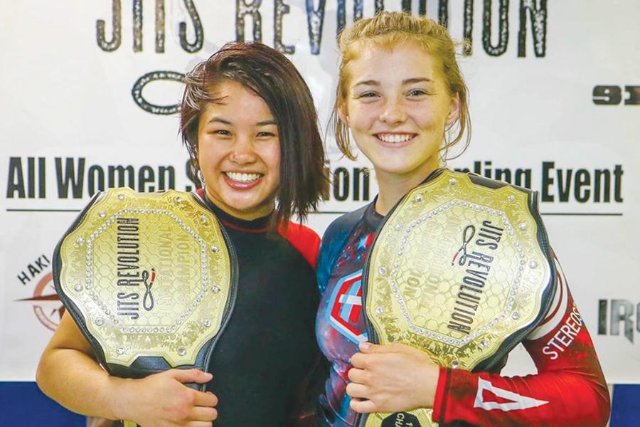 Senior Alex Nguyen (left) celebrates her victory at Jits Revolution – an all-women submission grappling event – with a fellow competitor. Nguyen has been competing in jiu-jitsu since she was 9. Her training has allowed her to excel in wrestling as well and she is the newest addition to the Nighthawk wrestling program. Submitted Photo
