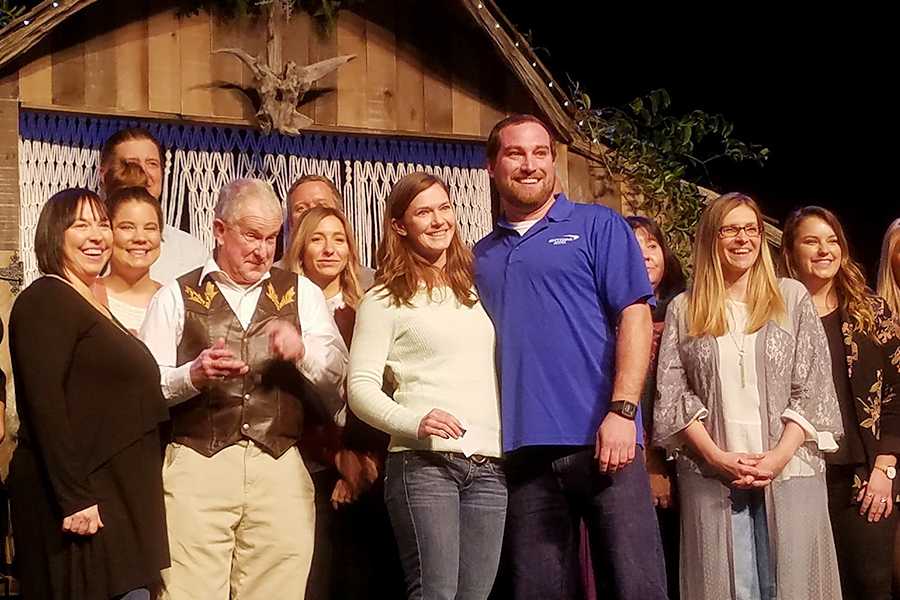 Science teacher Evan Miller stands in the spotlight with her fiance, Ben, after she won the "Dream Wedding" prize at last month's Outer Banks Wedding Expo. Submitted Photo