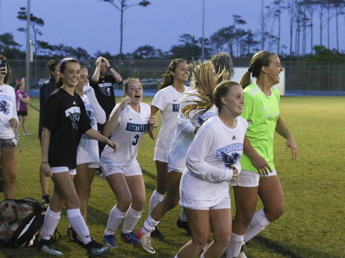 Members of the women's soccer team celebrate Wednesday's 4-0 victory against Carrboro that sent the Nighthawks into Saturday's championship game. PHOTO BY BUZZY STATEN/Nighthawk News