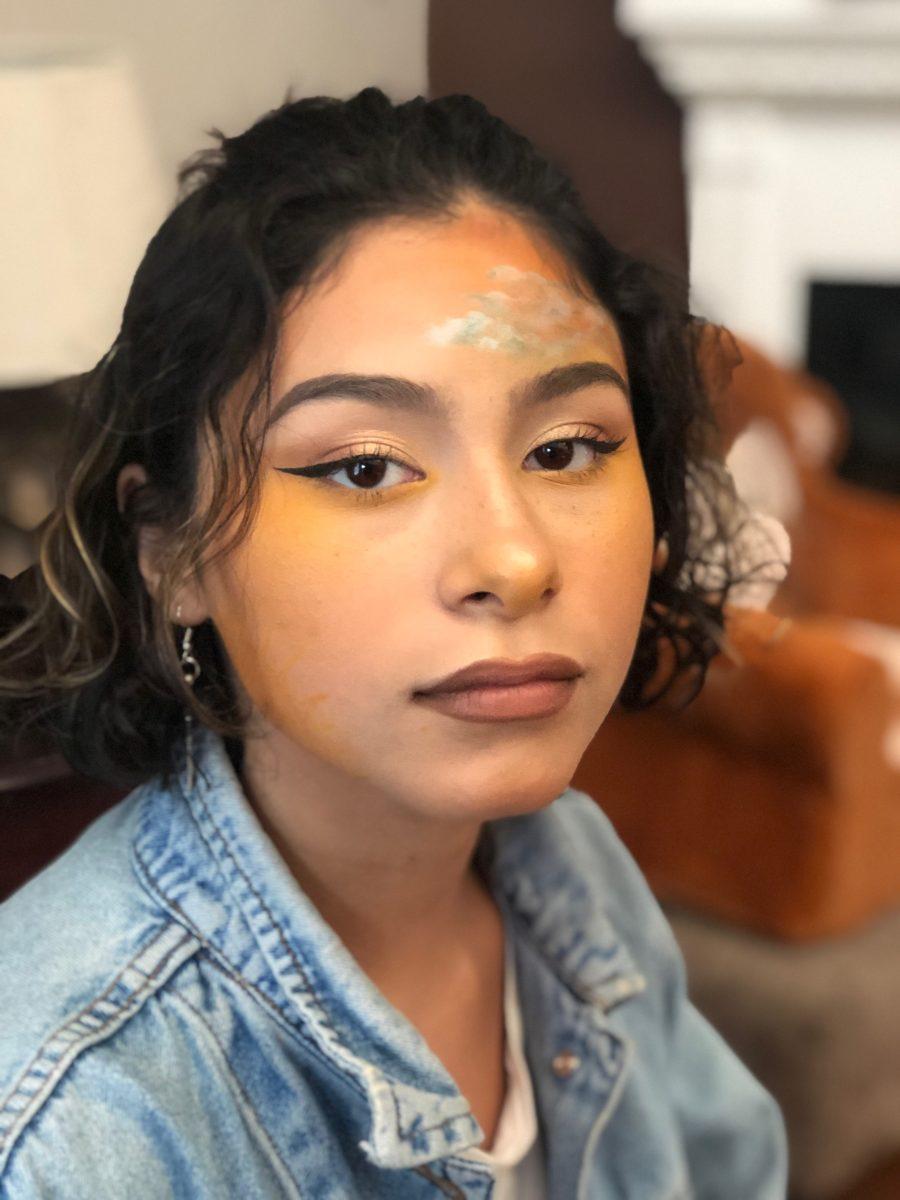 Senior Kimmy Fernandez shows off her finished makeup after working on perfecting her eyeshadow. Fernandez enjoys intricate makeup looks but will have to give them up when she joins the navy. 