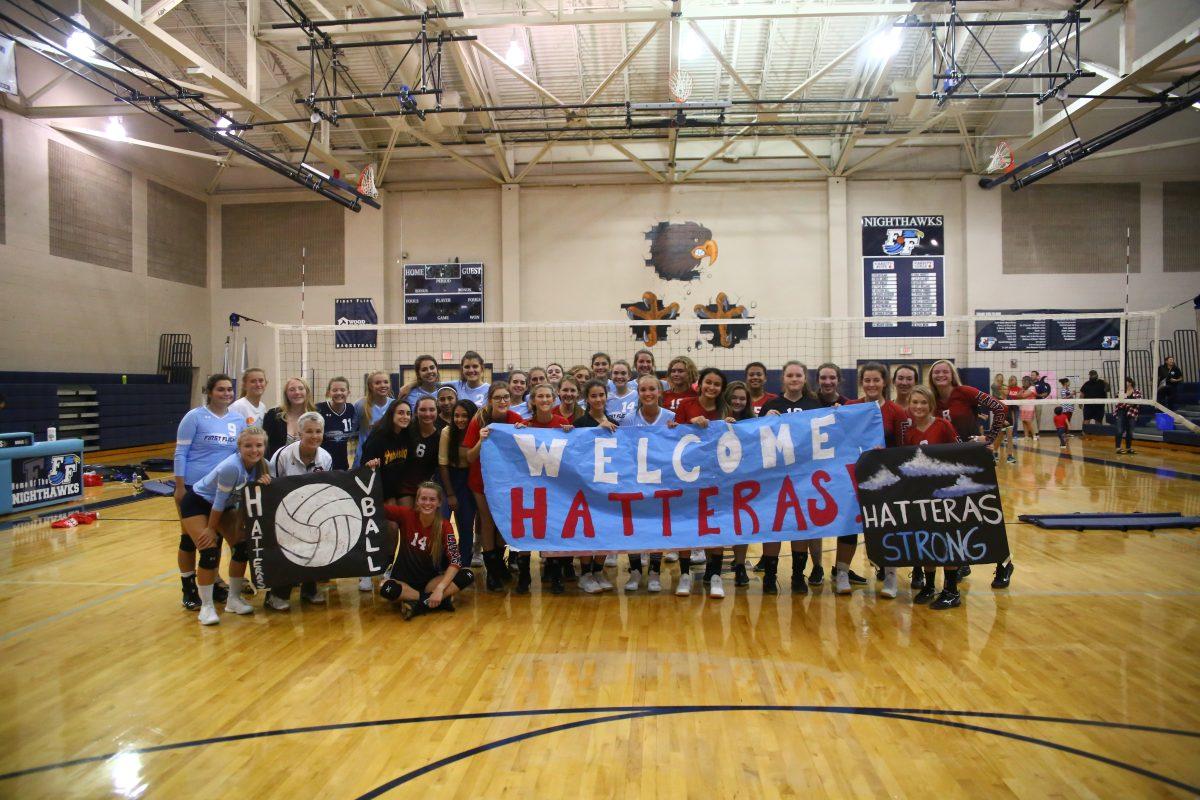 First Flight and Cape Hatteras volleyball players pose for a picture before attending a joined team meal after their match. PHOTO BY LEXI FOSTER/Nighthawk News