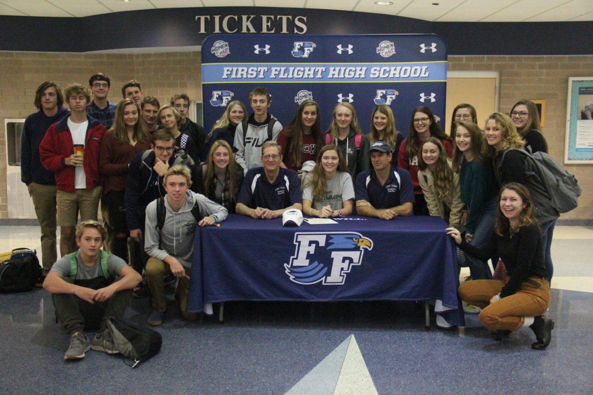 Senior Ashy King and her fellow swim teammates pose for a picture to celebrate King's commitment to William Peace University on Nov. 20. PHOTO BY TAYLOR NEWTON/Nighthawk News