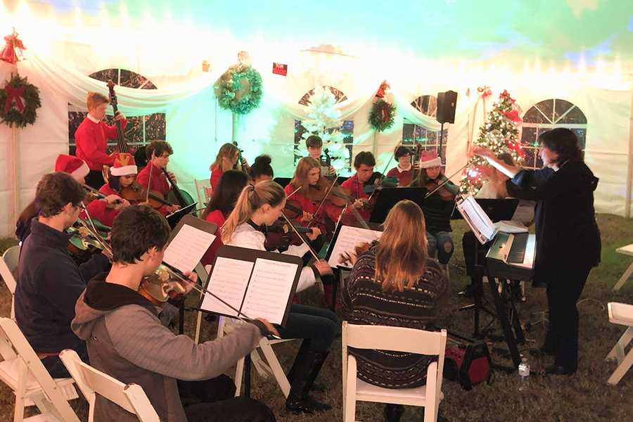 Different groups from First Flight and Manteo schools take turns offering entertainment at the Winter Lights. Last year, orchestra members played, but this year choir students performed. PHOTO SUBMITTED BY JOHN BUFORD