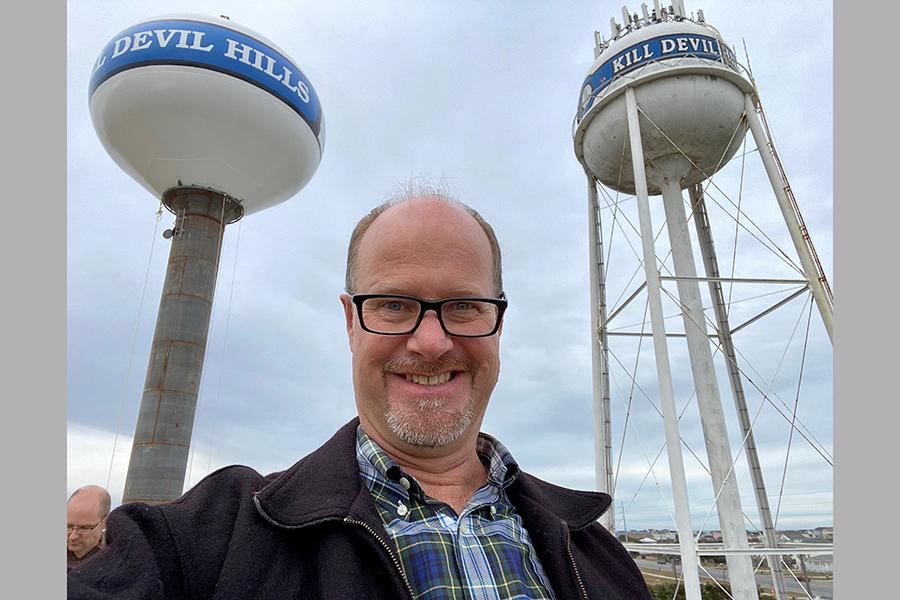 Kill Devil Hills Mayor Ben Sproul poses for a selfie with the town's new water tower (left) and the old water tower (right). PHOTO SUBMITTED BY BEN SPROUL