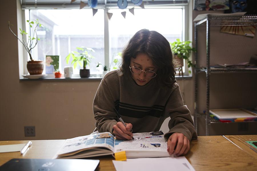 Senior Stella Nettles conveys her creativity from the pen to the page. PHOTO BY EMMY TRIVETTE/Nighthawk News