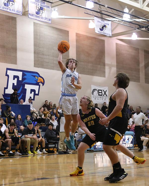 Dylan Blake (3) soars in the lane for a floater against rival Manteo earlier this season. Blake will be taking his shooting range and driving skills to ECU. PHOTO BY MADISON MURRY/Shorelines Yearbook