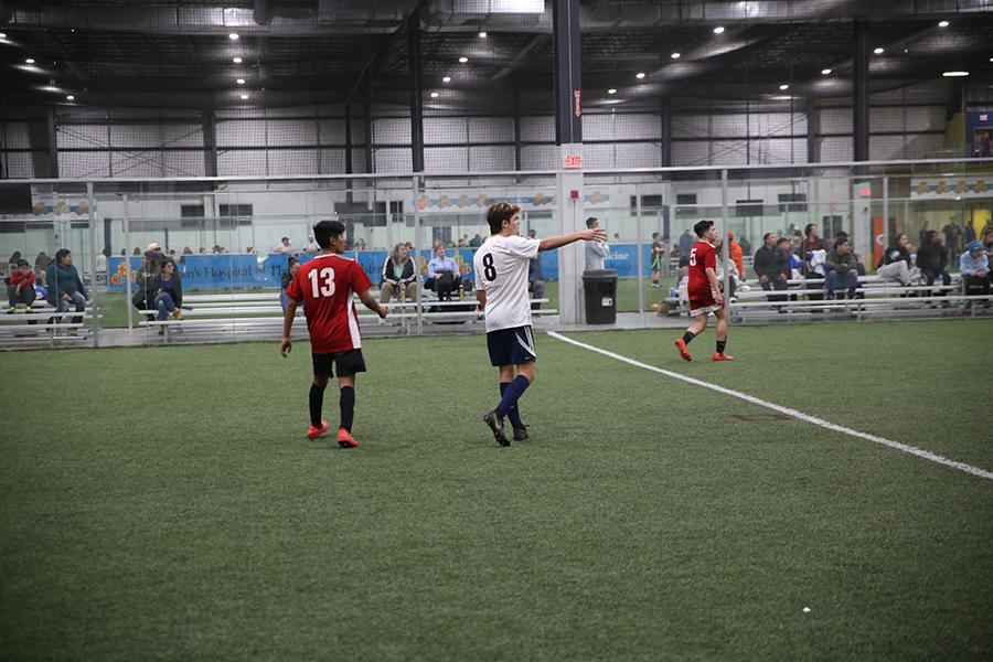 Sophomore Dominic Marino (in white) watches intently for the ball during an indoor soccer game at the Virginia Beach Field House on Jan. 19. PHOTO SUBMITTED BY MAGGIE MCNINCH/Nighthawk News