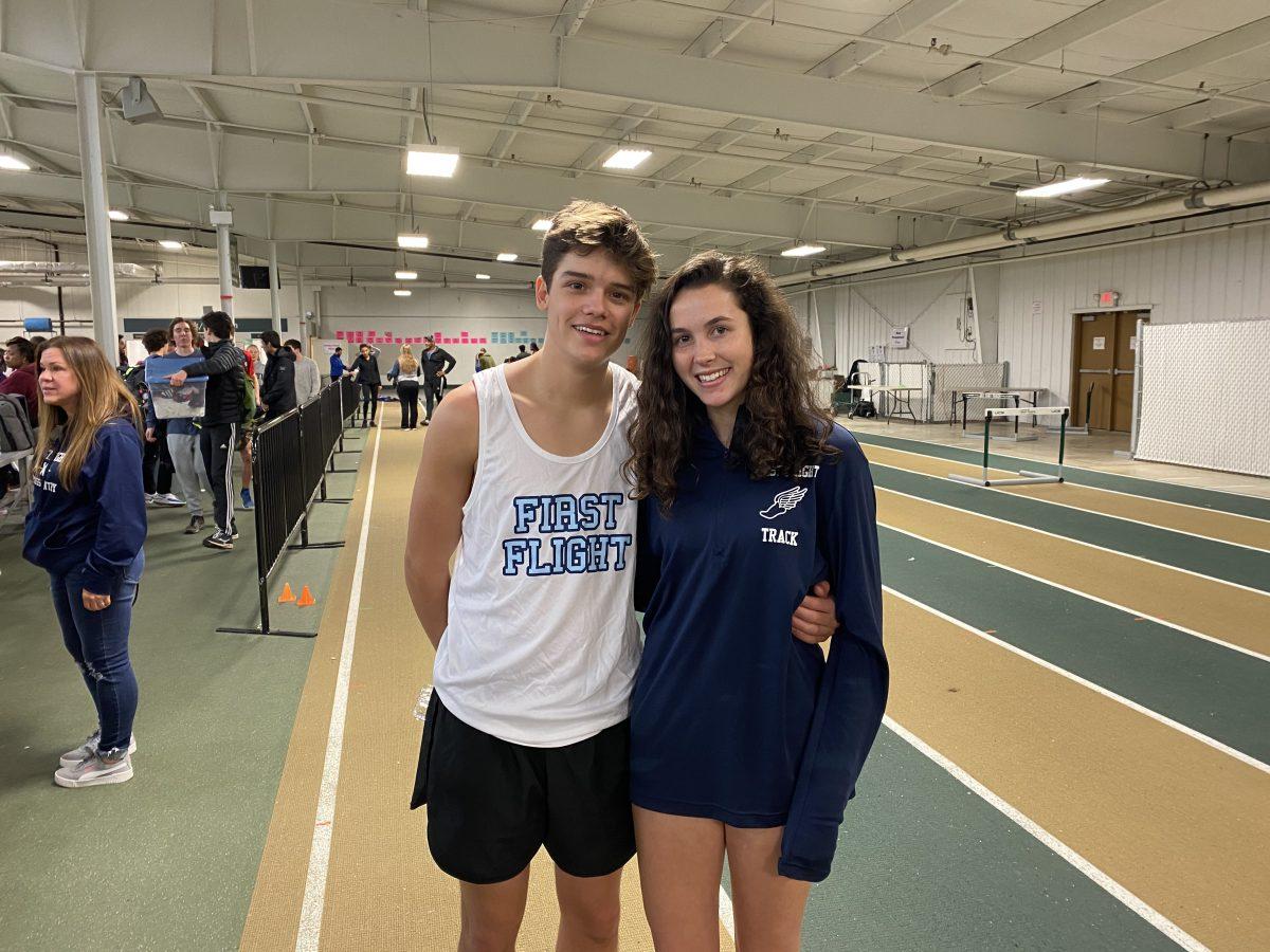 Senior Dominic Marino and Maggie McNinch stand together at track meet.