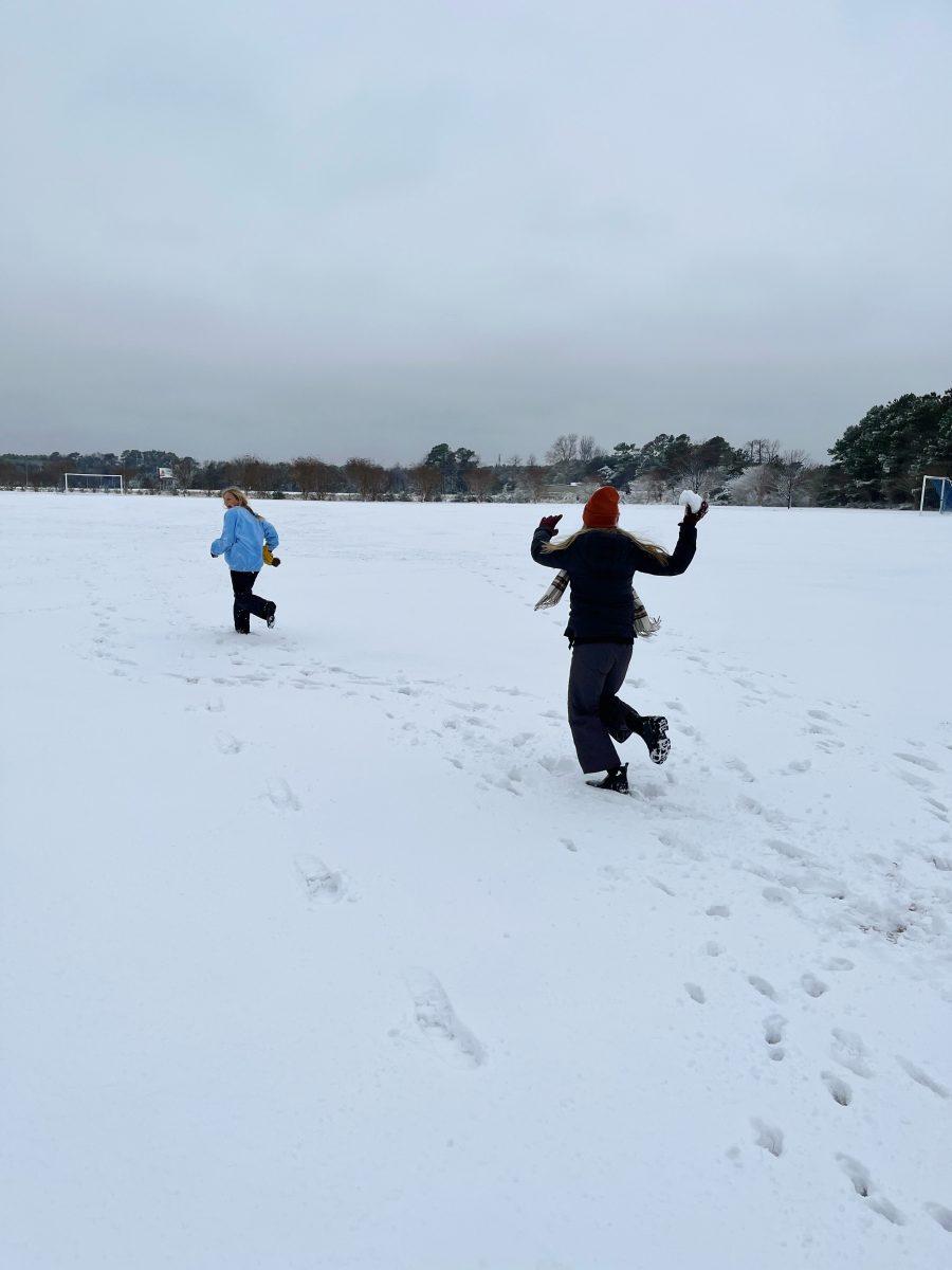 Senior Kate Hamilton chases sister in the snow.