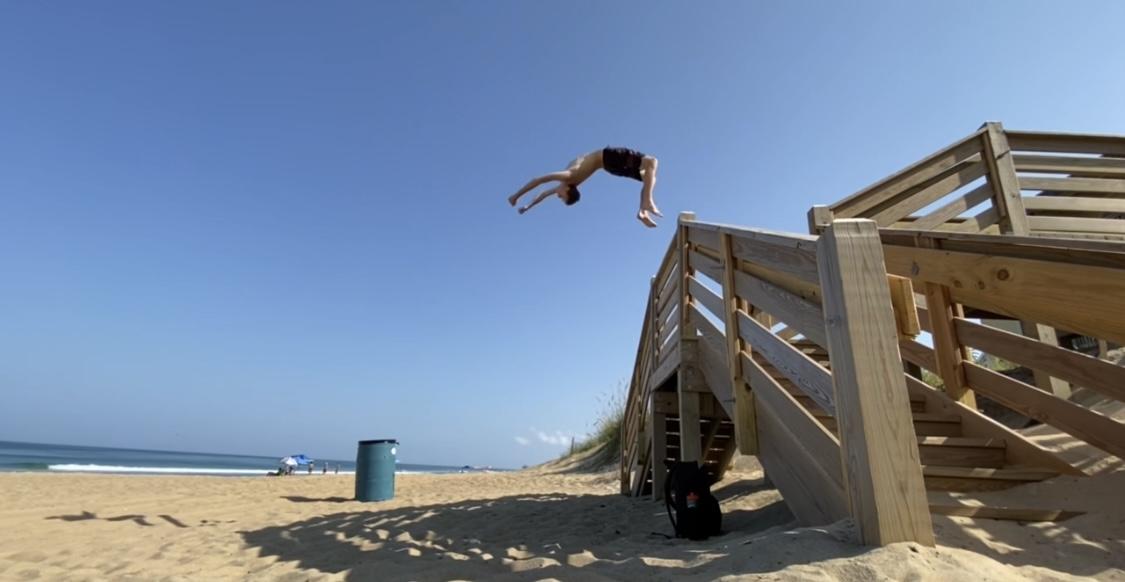 Fenton McKown completes a flip off of a beach access railing.