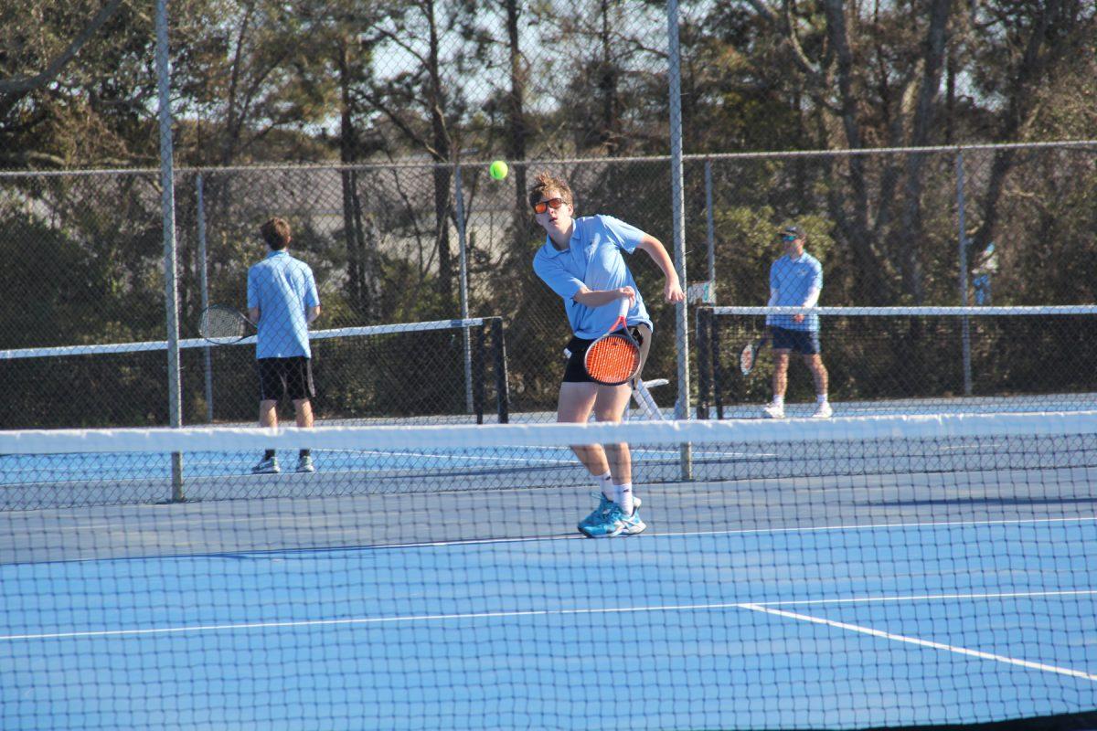 Sophomore J. J. Woerner serves a ball across the court. PHOTO BY SAMUEL SMITH/Nighthawk News